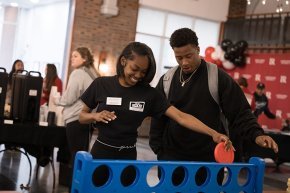 Amaya Saunders and another student play giant Connect Four at Bears Give Back