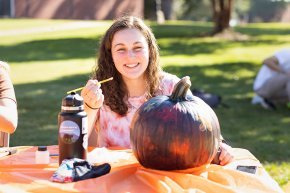Carly Godfrey at a pumpkin decorating activity on campus