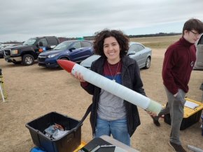 Demmi Ramos holding a rocket before a launch