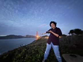 Demmi Ramos standing on a hill with the Golden Gate Bridge in the background