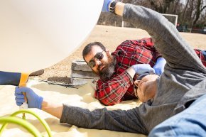 Mike Gerbits and Doug Knight prepare a weather balloon for launch from the soccer field