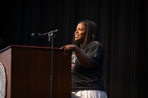 Tanli Carlton stands behind the podium to address first year students