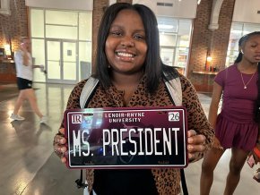 Tanli Carlton displays a custom LR license plate that reads "Ms President"