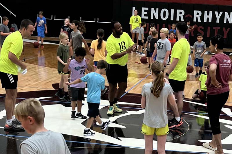 Youths in a gym participating in summer sports camp