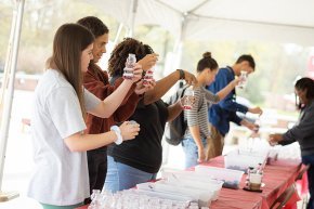 Students make sand art bears at Bears Give Back