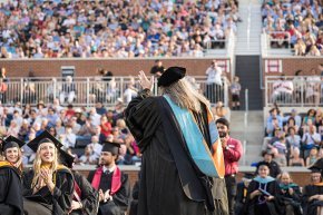 Dean Katie waving to the crowd at graduation