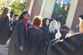 Students gathering in caps and gowns