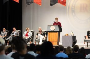 Samuel Fisher behind the podium at orientation