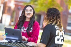 Students collaborating outdoors on campus