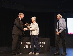 Staff members receiving award from President Fred Whitt