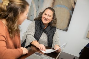 Alyssa Stewart, right, sits with a student