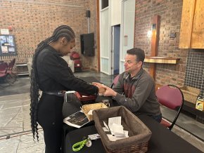 Student prays with University Pastor Todd Cutter.