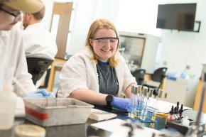 Sabrina Fredo smiles while working in a biology lab