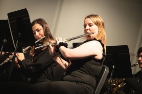 Sabrina Fredo plays flute in a performance with the wind symphony