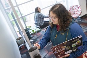 Christina Fisher works at her laptop in a space in George Hall