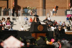 Kimberly Nanna stands behind the podium onstage in Moretz Stadium