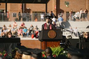 Diego Sanjuan speaks behind the podium on stage in Moretz Stadium