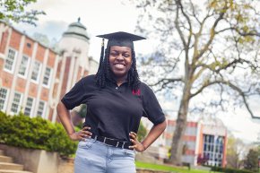 Kiera Elliott standing in front of the Rhyne Building