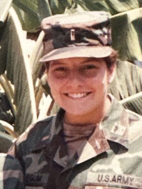 Rebecca Rabb in her uniform in front of tropical trees