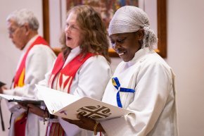 Three participants sing together in Christ Chapel