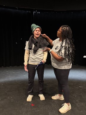 Two members of Bear With Us on stage playing an improv game at rehearsal