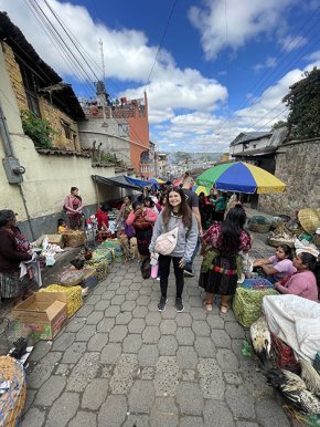 Alyssa Bailey walks through an outdoor market street in Guatemala