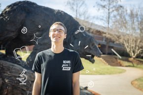 Hagan Suchocki standing in front of the Charge wearing a black Bears Give Back t-shirt