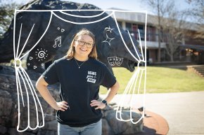 Megan Bedingfield wears a black Bears Give Back t-shirt and stands in front of the Charge