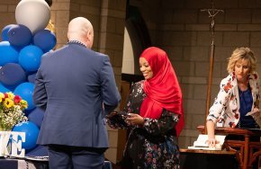 Jake Graffagnino presents the certificate and pin to a student during induction