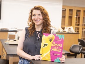 Carly York displays the cover of her book Queens of the Jungle
