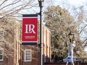 Banners on light posts along the quad by Mauney-Schaeffer during installation in late spring