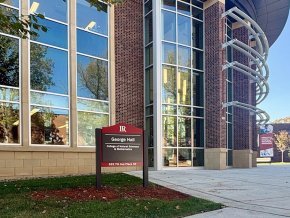 New campus building sign in front of George Hall