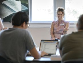 A professor speaks in front of a class