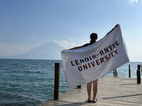 Alyssa Bailey displays her LR beach towel by a lake in the Guatemalan highlands