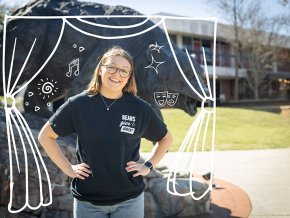 Megan Bedingfield wears a black Bears Give Back t-shirt and stands in front of the Charge