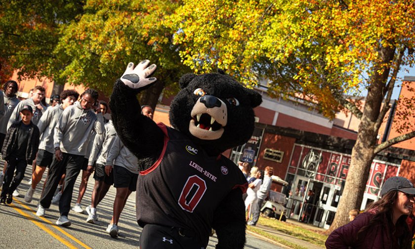 Joe Bear waves to the crowd at the homecoming parade