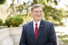 LRU President Dr Fred K Whitt smiling while looking off camera