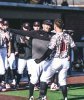 Baseball team members gather outside