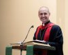 The Rev. Dr. Chad Rimmer stand at a podium